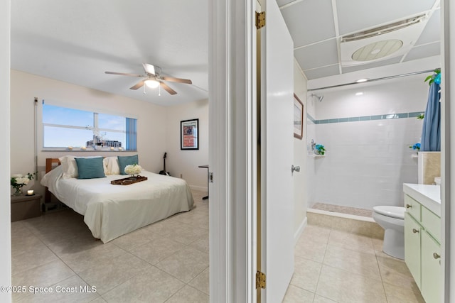 tiled bedroom featuring ceiling fan