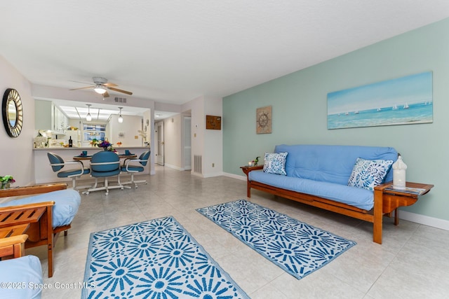 tiled living room featuring ceiling fan