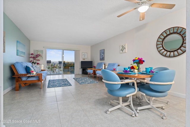 dining area with ceiling fan, a textured ceiling, and light tile patterned floors