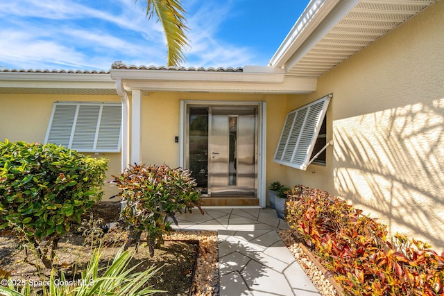 property entrance featuring a patio area