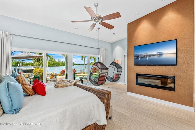 bedroom featuring ceiling fan, access to exterior, and light wood-type flooring