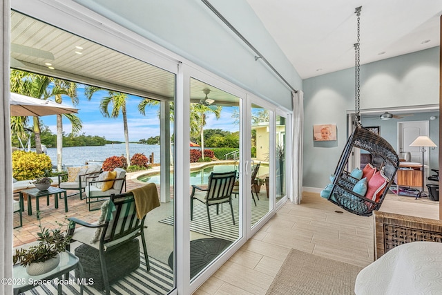 interior space with a water view, ceiling fan, and lofted ceiling