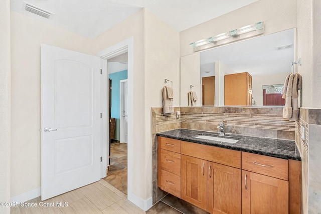 bathroom with vanity and backsplash