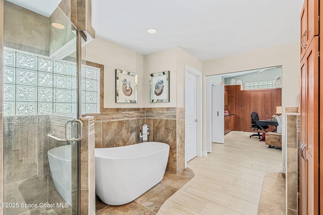 bathroom with plus walk in shower and tile walls