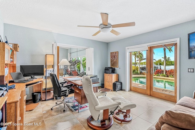 tiled home office featuring a textured ceiling, ceiling fan, and french doors