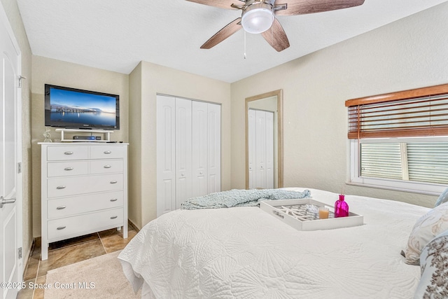 bedroom featuring light tile patterned floors and ceiling fan