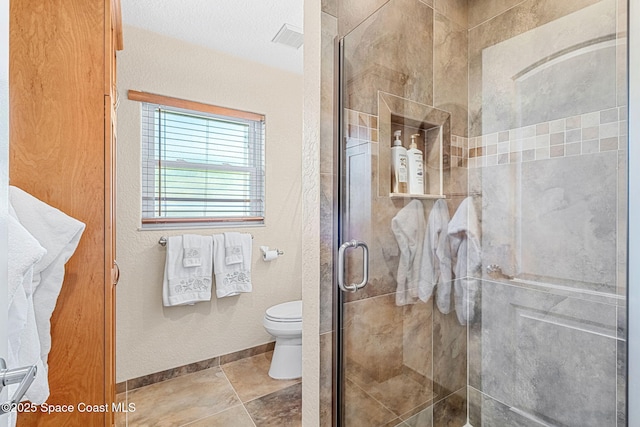 bathroom with toilet and walk in shower