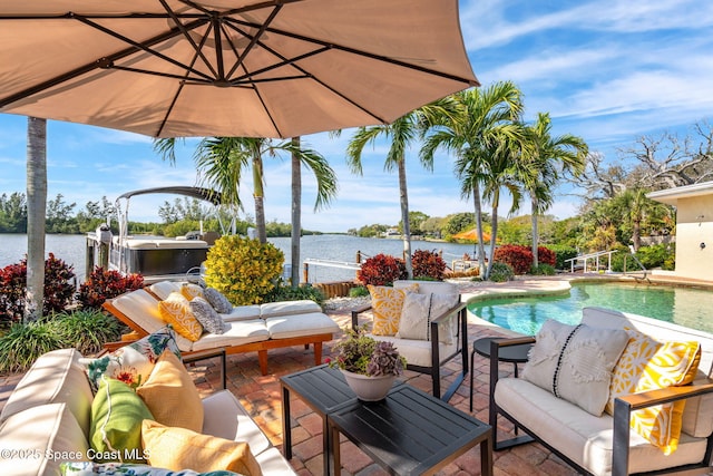 view of patio / terrace featuring a water view, an outdoor hangout area, and a pool with hot tub