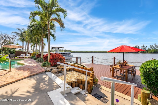 view of dock featuring a swimming pool side deck with water view