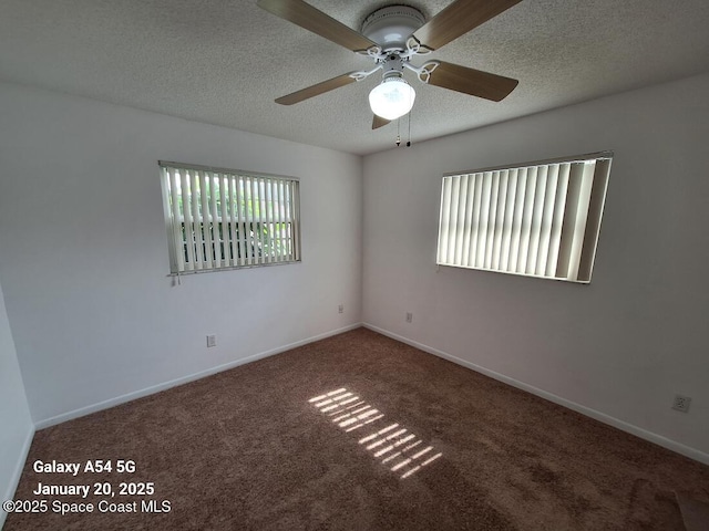 carpeted spare room featuring ceiling fan and a textured ceiling