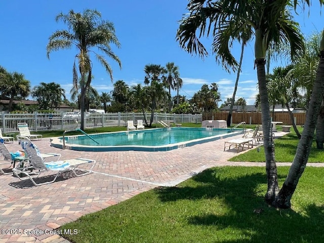 view of swimming pool featuring a yard and a patio