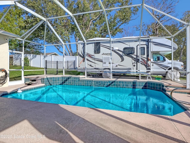 view of swimming pool with a lanai, a patio area, fence, and a fenced in pool