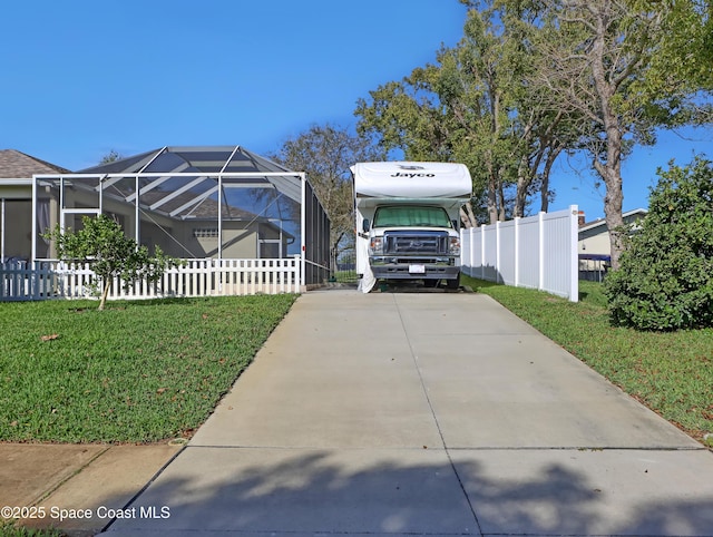 view of side of home featuring a lanai and a lawn