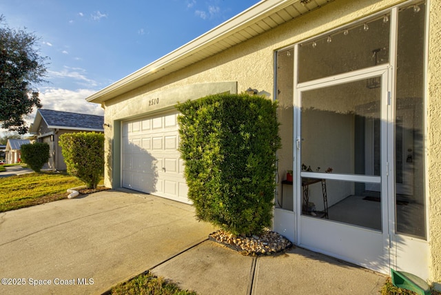 view of home's exterior with a garage and stucco siding