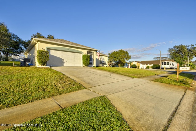 ranch-style home featuring concrete driveway, an attached garage, a front lawn, and stucco siding