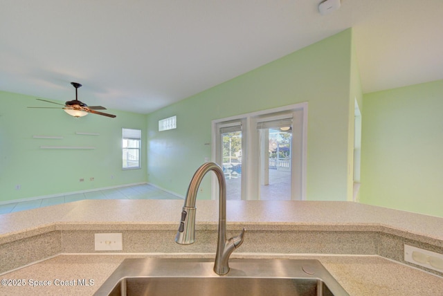 kitchen featuring a ceiling fan and a sink