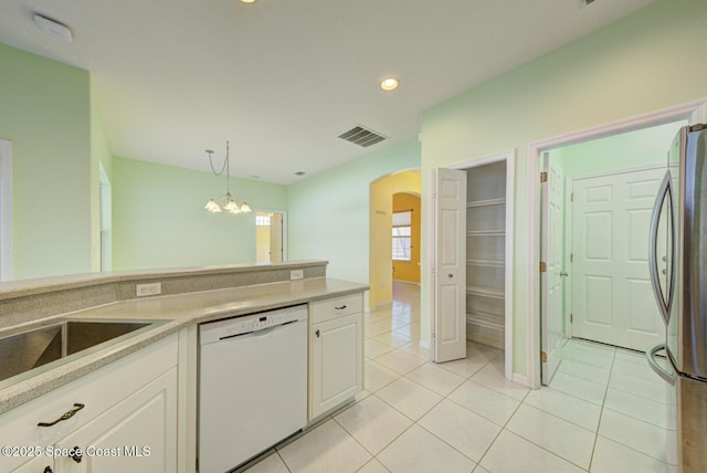 kitchen featuring stainless steel fridge, white dishwasher, decorative light fixtures, and white cabinets