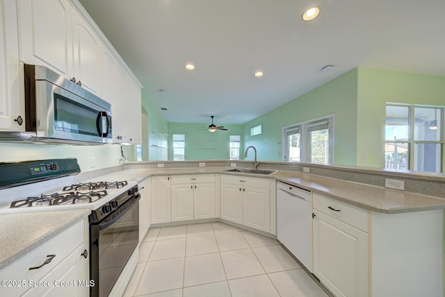 kitchen with light tile patterned floors, a sink, dishwasher, stainless steel microwave, and gas stove