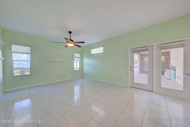 tiled empty room featuring ceiling fan