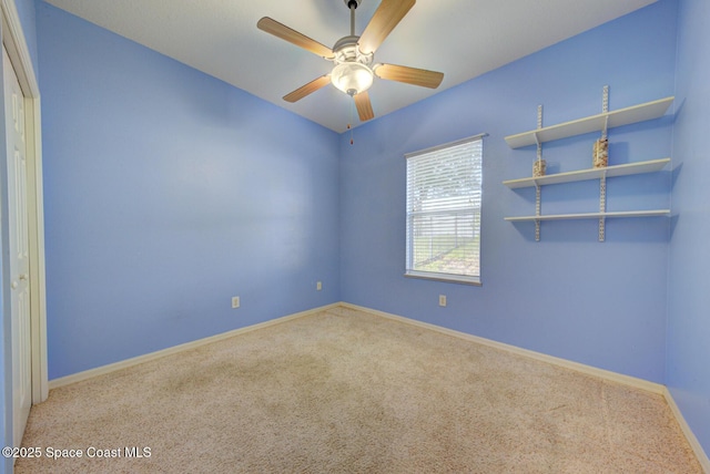 spare room with light colored carpet and ceiling fan