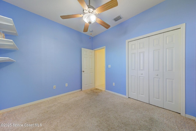 unfurnished bedroom featuring carpet, a closet, visible vents, and baseboards