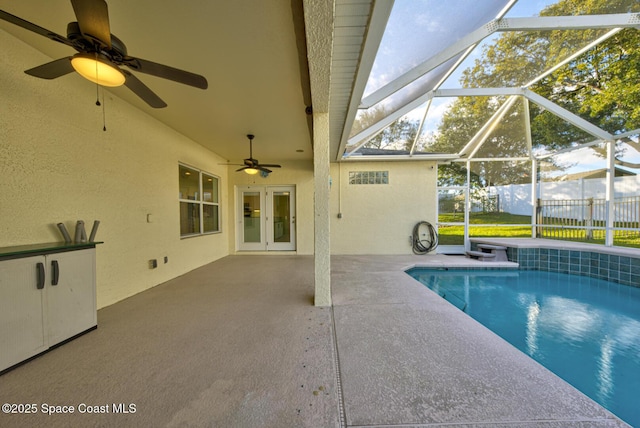 view of pool with a ceiling fan, a patio, a lanai, fence, and french doors