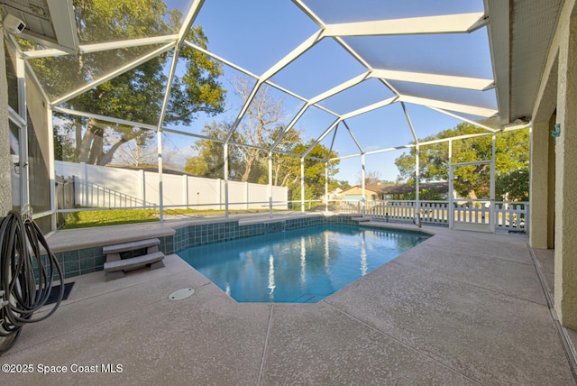 view of swimming pool with a lanai and a patio