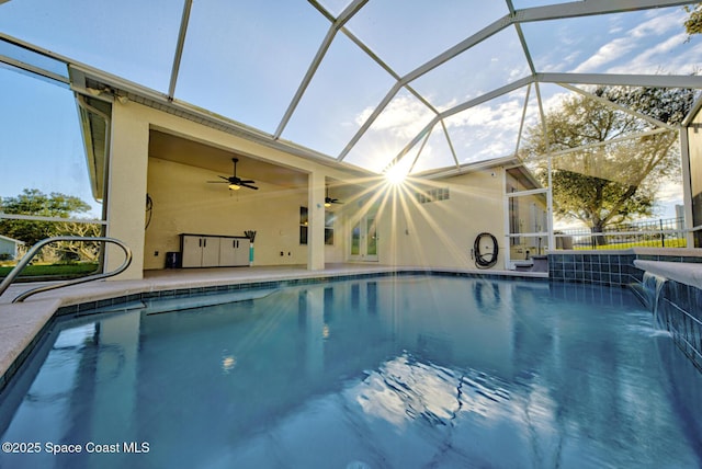 pool with a lanai, a patio area, ceiling fan, and fence