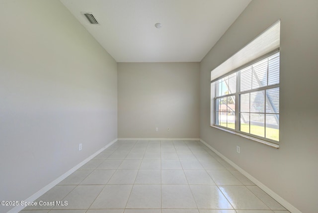 unfurnished room featuring visible vents, baseboards, and light tile patterned flooring