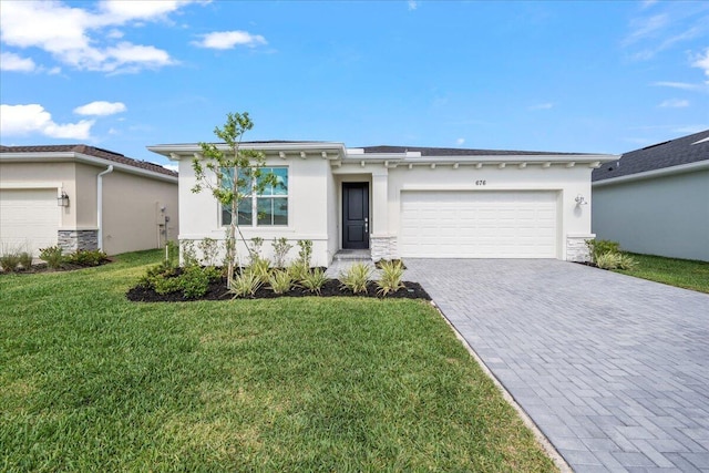 view of front of property featuring a garage and a front yard