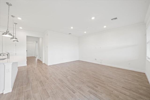 unfurnished room with light hardwood / wood-style floors and ornamental molding