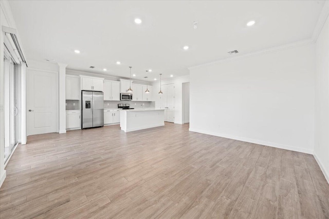 unfurnished living room featuring light wood-type flooring and ornamental molding