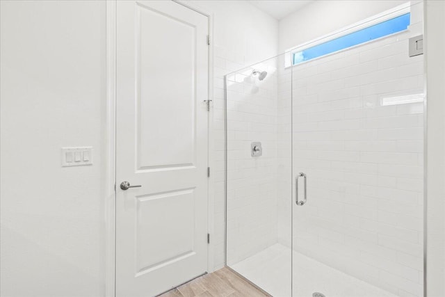 bathroom with a shower with shower door