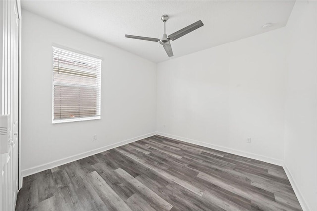 unfurnished room with ceiling fan and dark wood-type flooring