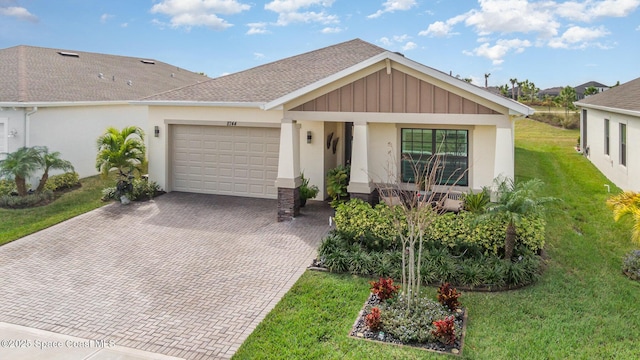 ranch-style house featuring a garage and a front yard