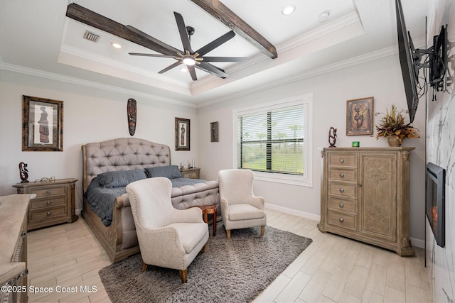 bedroom with crown molding, a raised ceiling, and light hardwood / wood-style floors