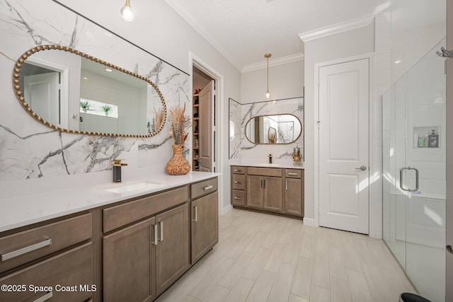 bathroom with a shower with shower door, tasteful backsplash, wood-type flooring, vanity, and ornamental molding