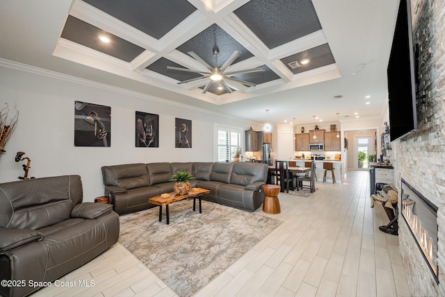 living room with light hardwood / wood-style flooring, plenty of natural light, and coffered ceiling