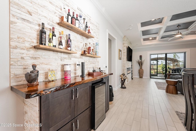 bar with wine cooler, ornamental molding, coffered ceiling, and butcher block countertops