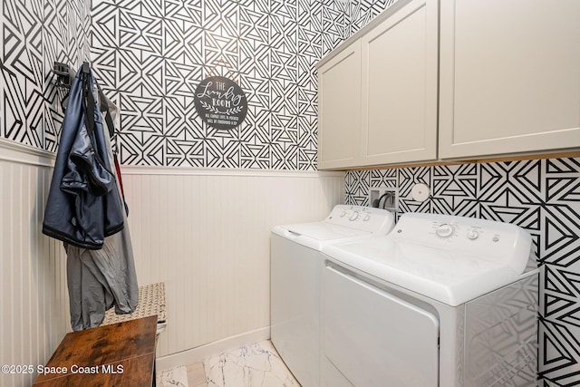 laundry area with cabinets and washer and clothes dryer