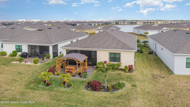 back of house featuring a lawn, outdoor lounge area, a patio, a water view, and central air condition unit