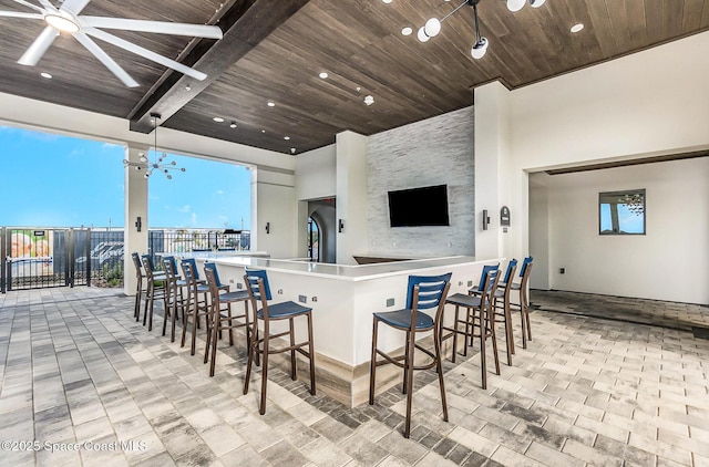 view of patio with ceiling fan and exterior bar