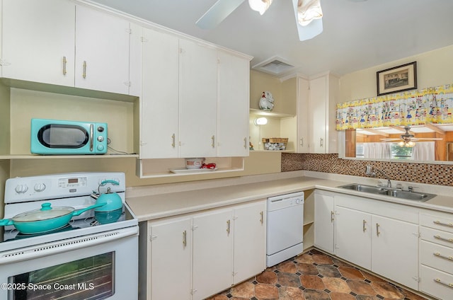 kitchen with white appliances, white cabinets, sink, backsplash, and ceiling fan