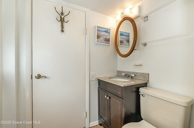 bathroom featuring toilet and vanity