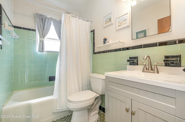 full bathroom with toilet, tile walls, vanity, and shower / tub combo with curtain