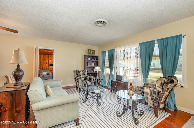 living room with a textured ceiling and hardwood / wood-style floors