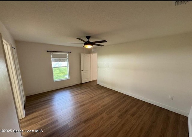 unfurnished room featuring ceiling fan and dark hardwood / wood-style floors