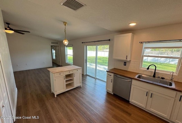 kitchen with decorative light fixtures, sink, white cabinetry, and dishwasher