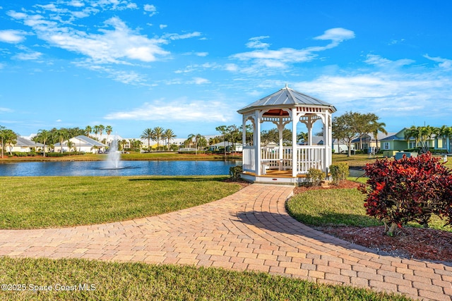 view of community featuring a gazebo, a water view, and a lawn