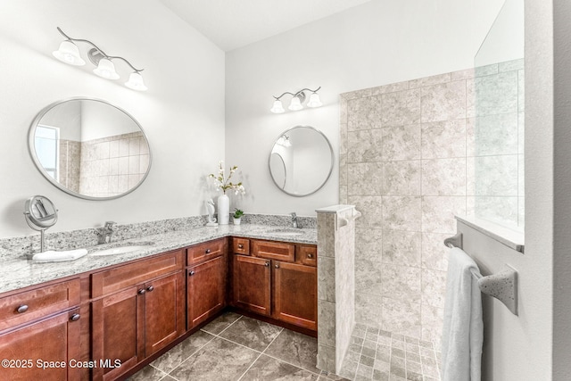 bathroom with tile patterned flooring, vanity, and walk in shower